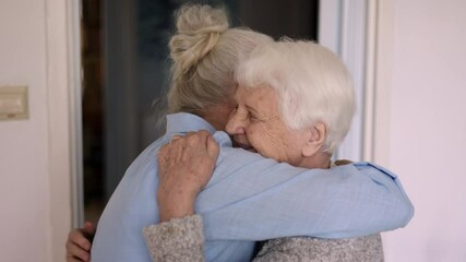 Daughter hugging Elderly mother 

