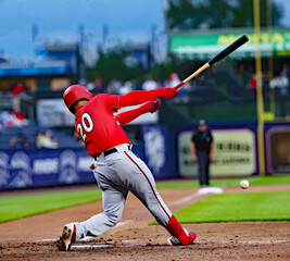 #20 baseball player hitting in red