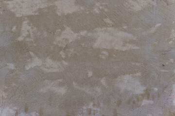 A grey wall with a white mesh pattern. The mesh is in the shape of squares.