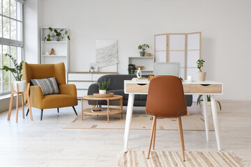 Interior of living room with programmer's workplace, sofa and armchair