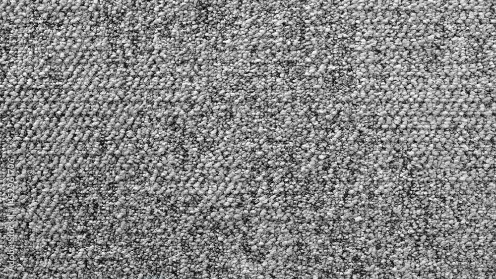 Aufkleber a gray and white carpet with a lot of small rocks on it. the carpet is very textured and has a lot o