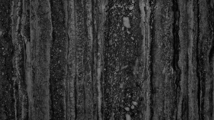 A wall with a black stripe and white spots.  wall is made of concrete and has a grey color.