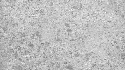 A stone wall with a variety of different sized rocks. The wall is made of a mix of white and gray stones.