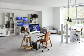 Interior of trader's office with desks and sofa