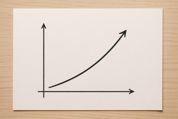 A simple hand-drawn exponential growth chart on white paper symbolizes business success, finance trends, and data analysis.