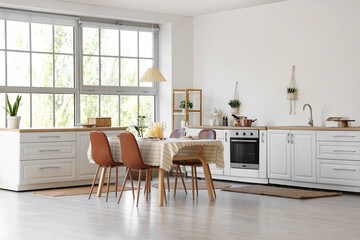 Served dining table with candles in kitchen