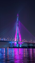 Fototapeta premium Illuminated cable-stayed bridge over a river at night. Vivid neon colors reflect on the water