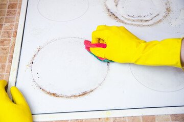 Gloved Hand Scrubbing Greasy Stove Circle Ring