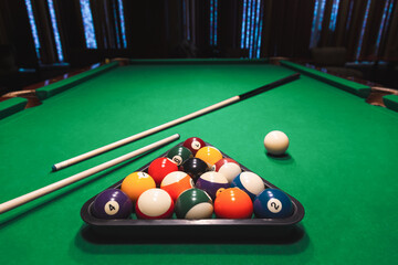 Triangle Rack of Pool Balls with Cues Green Billiard Tabletop