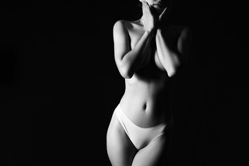 Naklejka premium Silhouette of attractive young woman on dark background