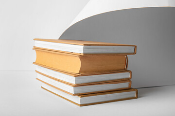 Stack of books on grey background