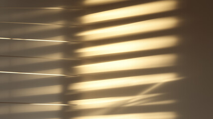 Soft sunlight casts striped shadows through closed window blinds onto neutral wall. Interior concept
