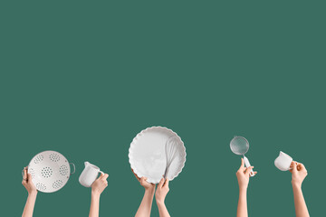 Female hands with kitchen utensils on green background