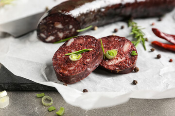 Tasty blood sausage on grey background, closeup