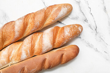 Fresh baguettes on white background