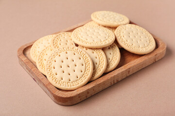 Wooden board with sweet cookies on brown background, closeup