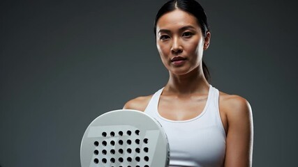 Padel tennis model poses confidently in studio setting showcasing athletic style and grace