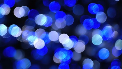 Fototapeta premium Abstract blue and white bokeh lights creating a dreamy atmosphere.