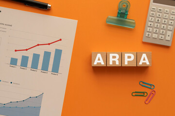 There is wood cube with the word ARPA. It is an abbreviation for Average Revenue per Account as...