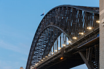 Close-up view of Sydney Harbour Bridge with blue dusk sky.
