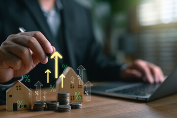 Real estate investor analyzing property value growth with stacked coins, houses, and upward arrows,...