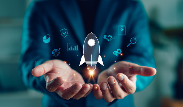 Businessman hands holding rocket icon with digital business elements, symbolizing startup launch, innovation, growth strategy, entrepreneurship and future success in modern business.
