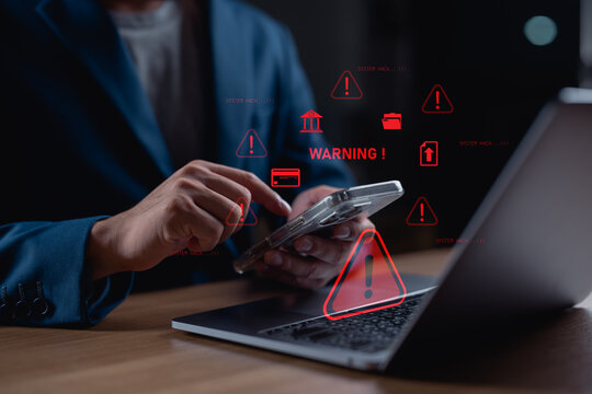 Businessman receiving cybersecurity warning on smartphone with system hack alerts. Concept of data breach, hacking, online security risk, cyberattack, and internet safety technology.