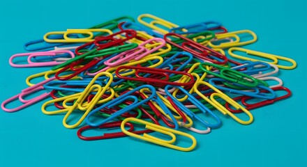 Colorful paper clips stationery office supplies back to school essentials organization clip heap scattered
