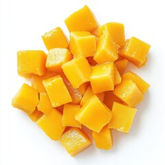 Pile of diced mango fruit pieces on a white background