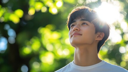 Youthful Hope: A Young Man Gazes Towards the Sunlit Canopy