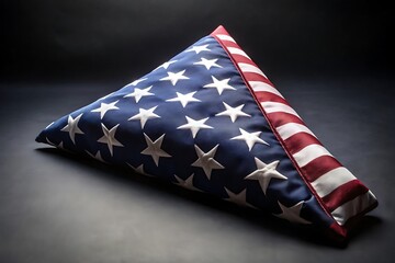Obraz premium Solemnly Folded American Flag Resting on a Dark Gray Background Surface