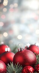 Festive holiday background with red Christmas ornaments and bokeh lights