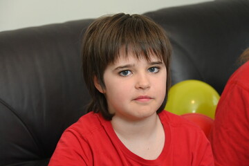 child blowing up balloons for birthday