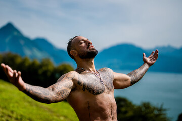 Powerful man on nature. Sexy shirtless man splashing under waterfall. Fit and strong male body in nature. Sexy model enjoying summer. Male beauty. Muscular torso with water drops. Topless guy in