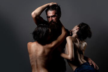 Sensual threesome kiss. Intimate relationship and sexual relations. Passion and sensual. Couple In Love. Romantic and love. Threesome concept. Three sexy models together. One man and two sexy women.