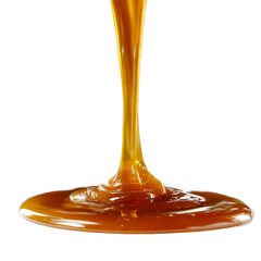 Close up of caramel sauce pouring down onto a surface against a black background studio shot