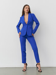 Striking blue attire showcases elegance and confidence in a modern studio setting