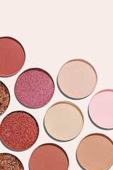 Colorful Swatches eyeshadow refills as minimal geometric pattern. Matte, glitter pans red brown pink shade with sun shadows, detailed texture, cosmetic, beauty product, makeup, warm color scheme