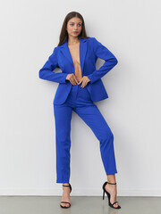 Bold blue suit brings elegance and confidence in a studio fashion pose