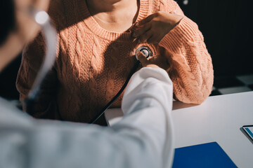 The doctor examines the patient's heart to analyze and listen to whether the heart rhythm is...
