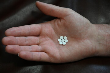 pills in hand and illness