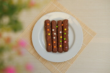 The bars appear rich and textured, likely containing nuts, oats, or crispy cereal inside the chocolate coating