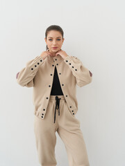 Fashionable female model poses in a modern studio showcasing stylish casual wear