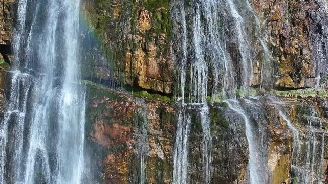 Aerial Bridal Veil Falls water rocks Provo Utah close descend 1. 607 foot tall double cataract waterfall in Provo Canyon. Rugged rocky ledges and cliffs over pine forests. Deep canyon valley. Summer.