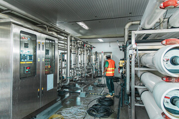 Male worker install is using Industrial electrician engineer tests electrical box
