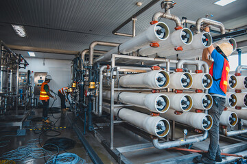 Male worker install is using Industrial oxygen tanks in chemical factory. Oxygen storage vessels, which is either held under pressure in gas cylinders, or as liquid oxygen