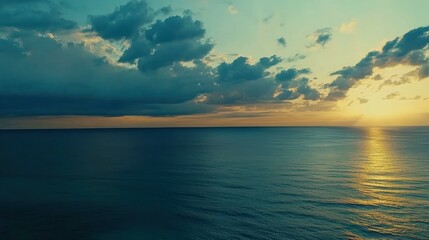 Fototapeta premium Ocean view with rising sun and clouds in a scenic and peaceful landsca