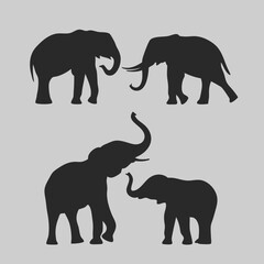 Fototapeta premium Majestic elephant silhouettes a captivating collection of four elegant black profiles against a muted grey backdrop