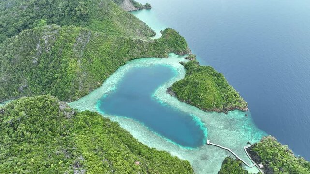 A scenic heart-shaped lagoon is found in the island of Karawapop near Misool, Raja Ampat. This tropical area is known for its extraordinary marine biodiversity.