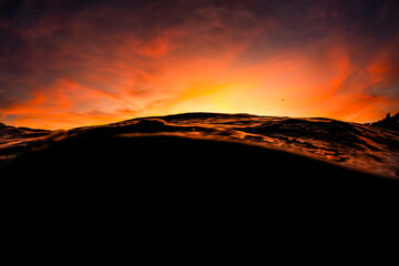 Golden sunset over the ocean as seen from the surface off Sydney, Australia.